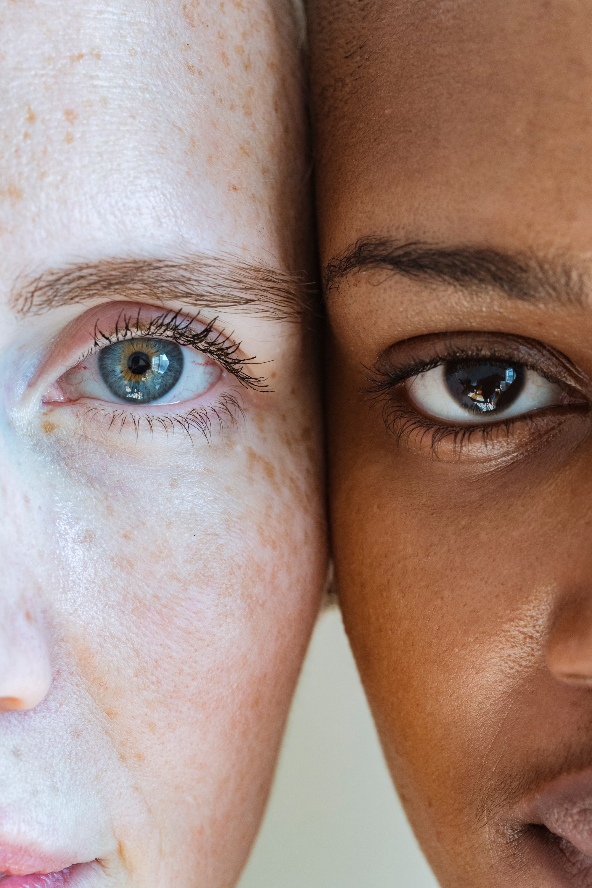 Woman with freckled face near black model